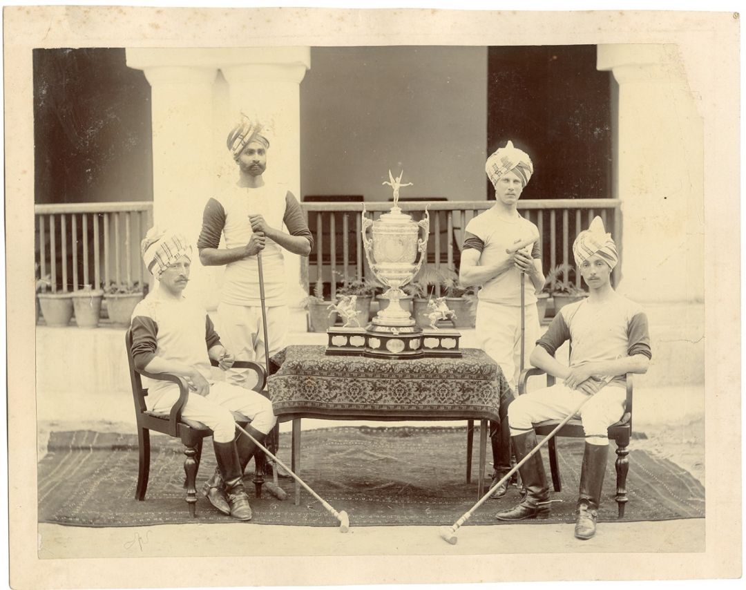 Winners of the Polo Tournament Posing with their Victory Trophy